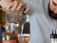 bartender pouring a mixed drink
