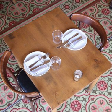place setting for two on classic tile floor