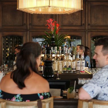 two people sitting at a bar
